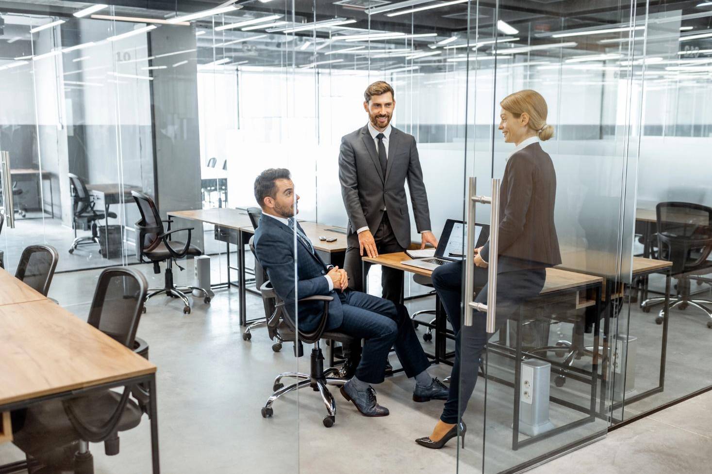 Business people in a glass partition during a discussion at the workplace.