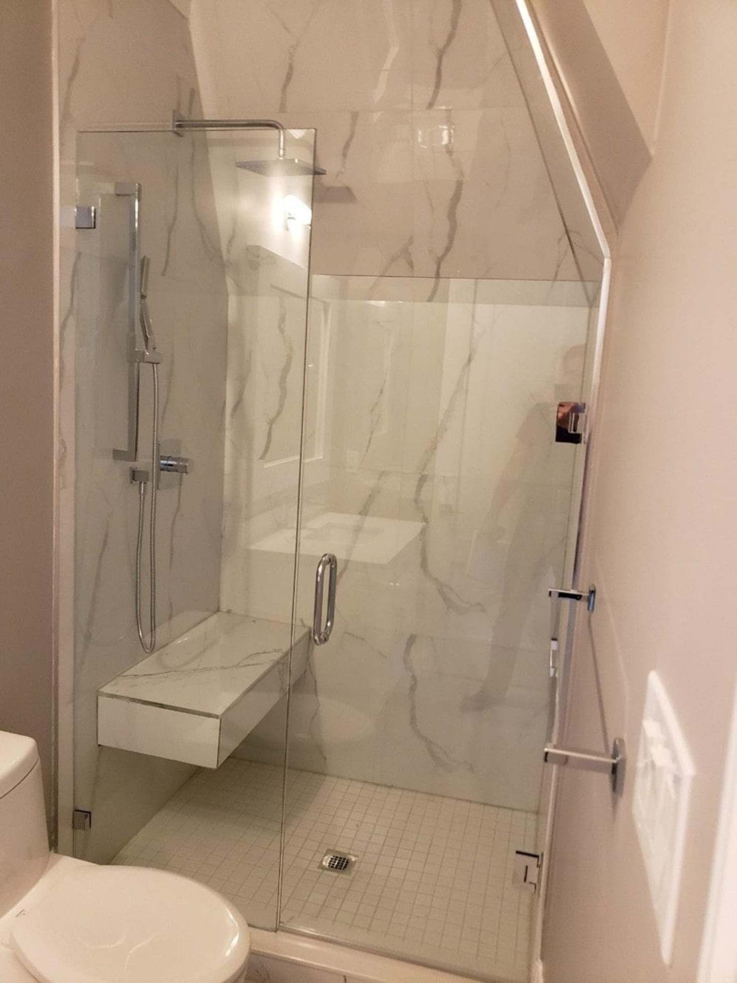 A frameless glass shower customized into a small bathroom