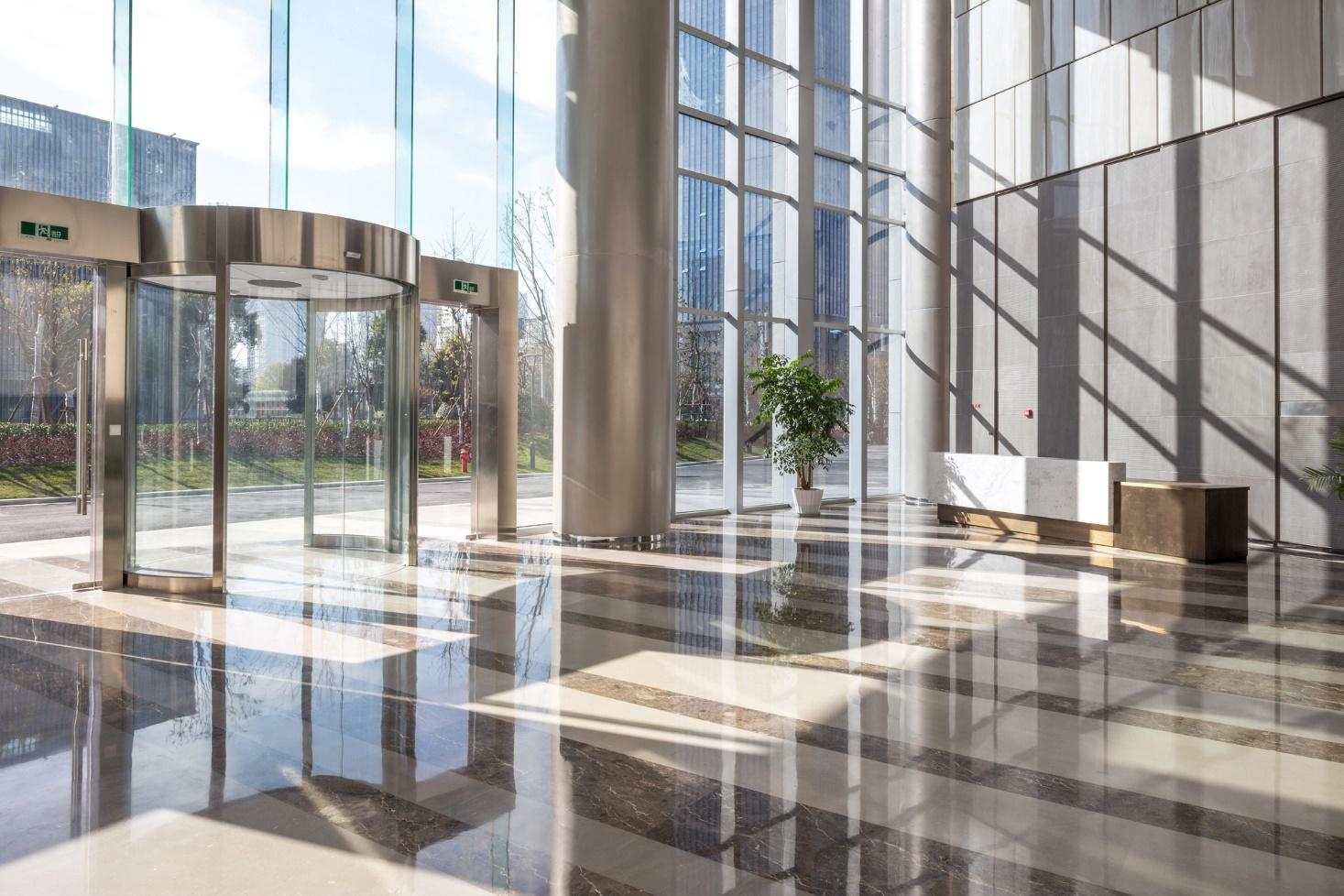 Lobby of a hotel with glass panels.